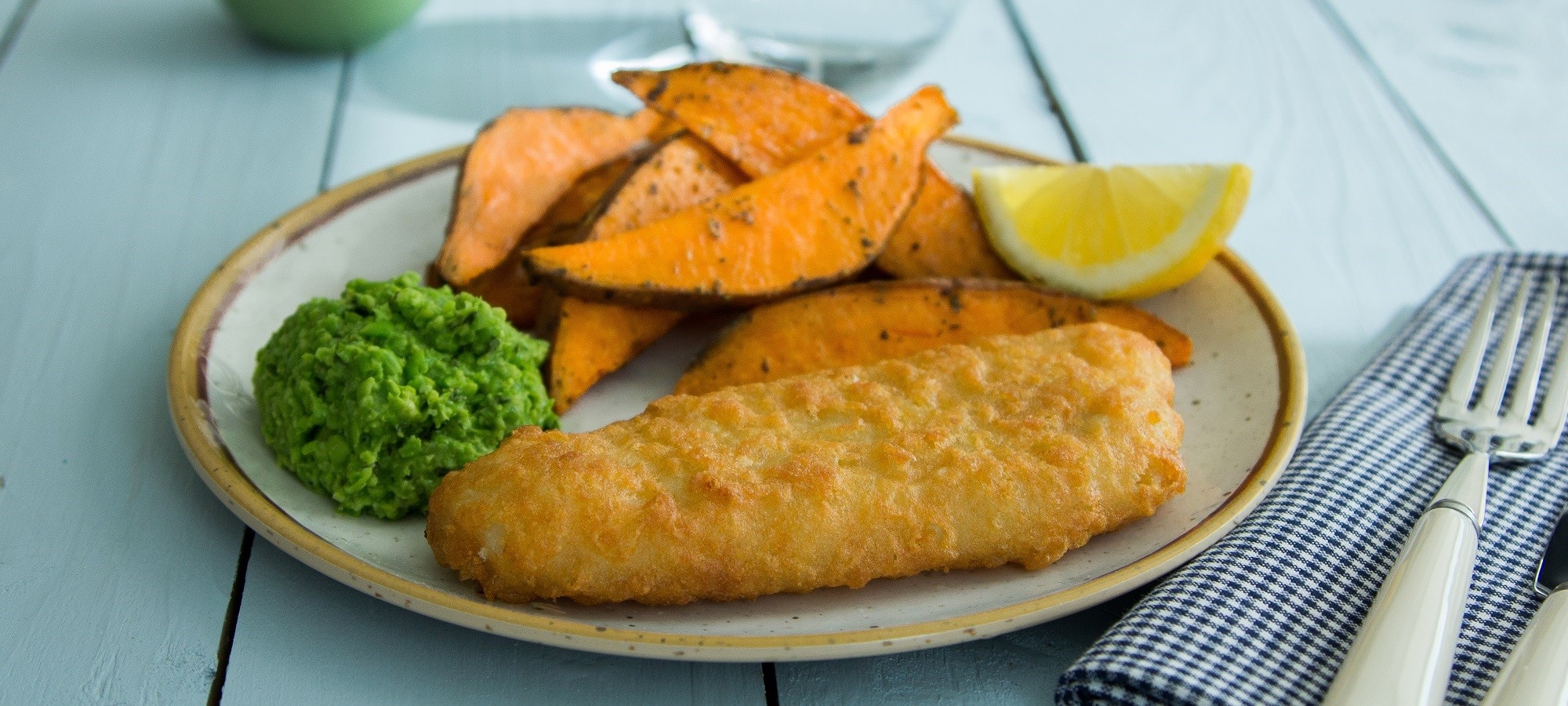 Battered Cod fillets with sweet potato wedges and minty crushed peas